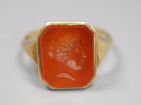 A continental yellow metal and intaglio carnelian set signet ring, carved with head of a lady to sinister, size N/O, gross 4.1 grams